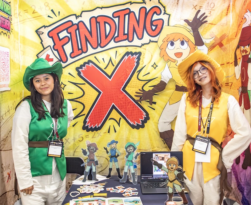 Two students presenting their project at an Infomatrix exhibition stand.